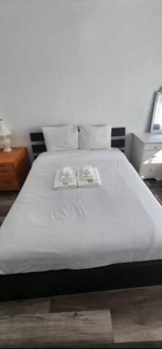 a white bed with two pillows on top of it at Affordable Private Rooms with Shared Bath Kitchen near SFO (SA) in Daly City