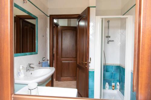a bathroom with a sink and a tub and a shower at Il Rustico di Pino in Custonaci