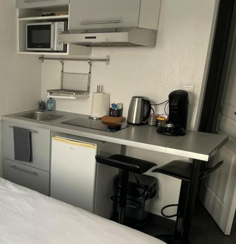 Il comprend une petite cuisine avec un évier et un comptoir. dans l'établissement Studio1 proche Fac climatisé, à Albi