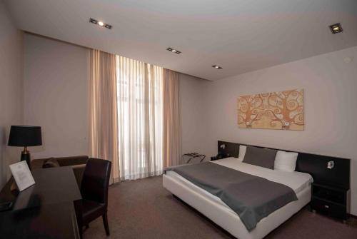 Postel nebo postele na pokoji v ubytování Hotel Platani