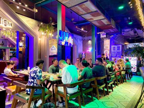 a group of people sitting at tables in a restaurant at Moonlight Villa in Phnom Penh
