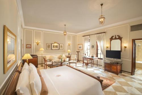 a bedroom with a bed and a living room at The Imperial, New Delhi in New Delhi