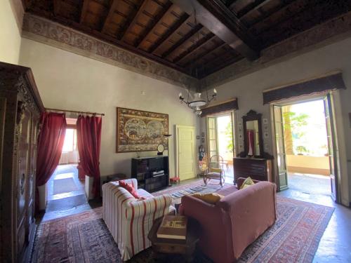 a living room with two couches and a fireplace at Palazzo Ronchelli in Castello Cabiaglio