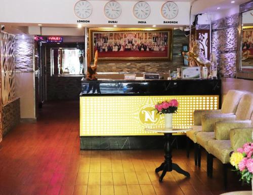 a bar in a restaurant with a counter and chairs at Abunawas Merry Inn at Walking Street in Pattaya South