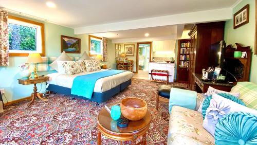 a bedroom with a bed and a living room at Ah House City B&B Nelson in Nelson