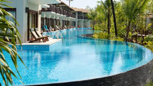 a pool at a resort with blue water at The Haven Khao Lak in Khao Lak