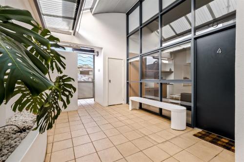 an empty room with a bench in a building at 107 Apartments Margaret River in Margaret River Town