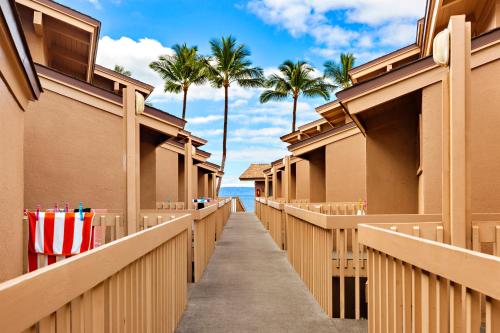 a walkway leading to the beach with palm trees at Kihei Sands B2 in Kihei