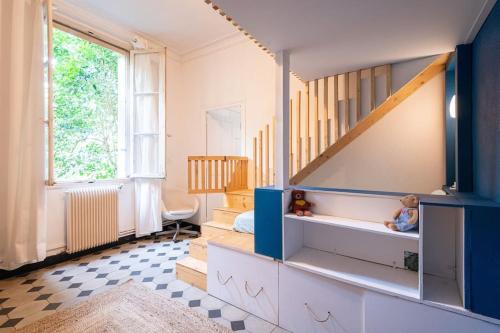 a childs room with a bunk bed and stairs at Le petit marin, clim/wifi/quartier gare-arènes. in Nîmes