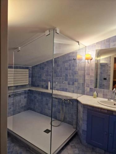 a bathroom with a glass shower with a sink and a counter at DOMUS SAN CARLO LOFT in Caserta