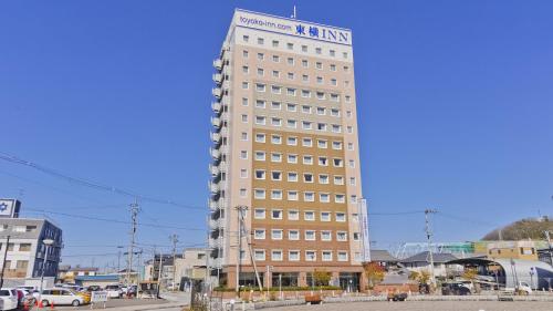 a tall building with a sign on top of it at Toyoko Inn Maibara eki Shinkansen Nishi guchi in Maibara