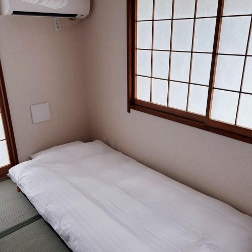 Ein Bett oder Betten in einem Zimmer der Unterkunft Shiki no Sai Asakusa