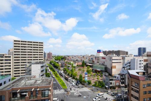 a view of a city with buildings and cars at Kameari 1003 Budget Stay High Floor Near Station Mall Disney Access in Tokyo