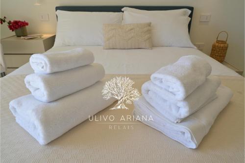 a bed with two towels on top of it at Relais Ulivo Ariana in Gaeta