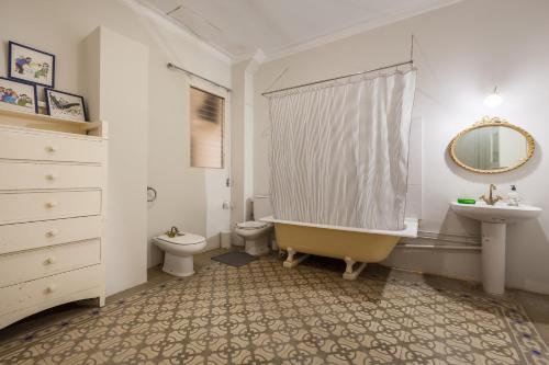 a bathroom with a tub and a toilet and a sink at Casanova in Vallromanes