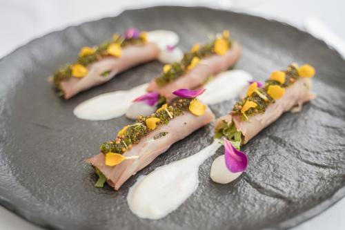 a plate with four different types of food on it at Grand Hotel Slavia - Adults only in Baška Voda
