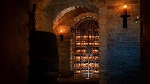 a wall with a gate with bottles of wine at Villa Bostele with Five Bedrooms, Indoor Pool, Two Saunas & Garage in Bad Kleinkirchheim
