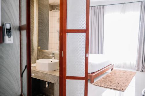a bathroom with a sink and a mirror at S 2 Modern Boutique Hotel in Vientiane