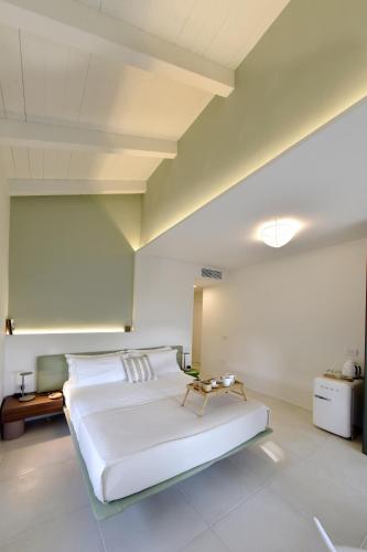 a bedroom with a large white bed in a room at Relais Ulivo Ariana in Gaeta