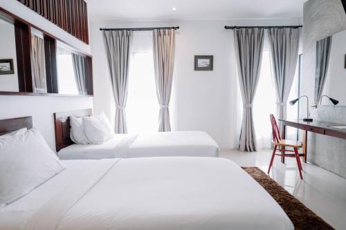 a hotel room with two beds and a desk at S 2 Modern Boutique Hotel in Vientiane