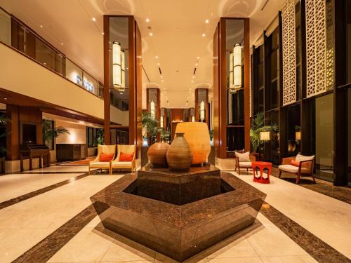 a lobby with a fountain in the middle of a building at Hyatt Regency Naha, Okinawa in Naha