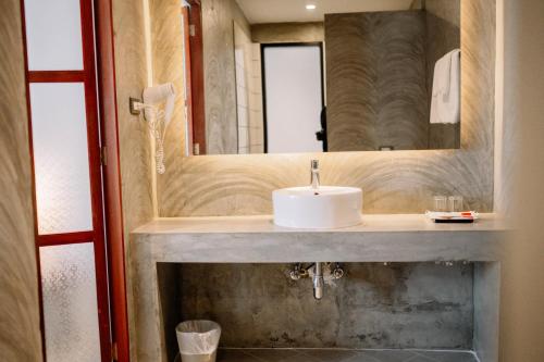 a bathroom with a sink and a mirror at S 2 Modern Boutique Hotel in Vientiane