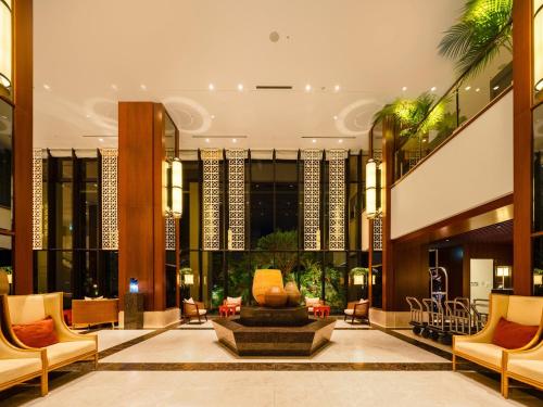 a lobby with a fountain in the middle of a building at Hyatt Regency Naha, Okinawa in Naha