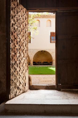 an open door with a view of a courtyard at Santuario Virgen de la Fuente in Peñarroya de Tastavins