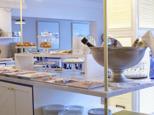 a bakery counter with a bowl of food on a table at Hotel Els Pins in Platja  d'Aro