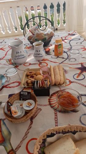 a table topped with food and bowls of food at B&B La Collina in Posada