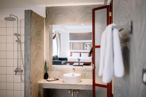 a bathroom with a sink and a bathroom with a bedroom at S 2 Modern Boutique Hotel in Vientiane