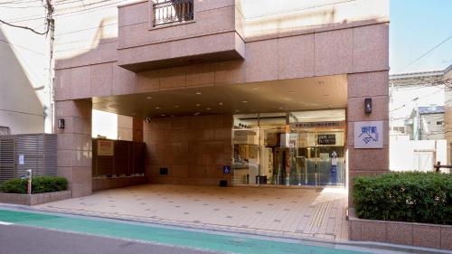 a store front of a building on a street at Toyoko Inn Tokyo Shinagawa Hatanodai eki Minami guchi in Tokyo