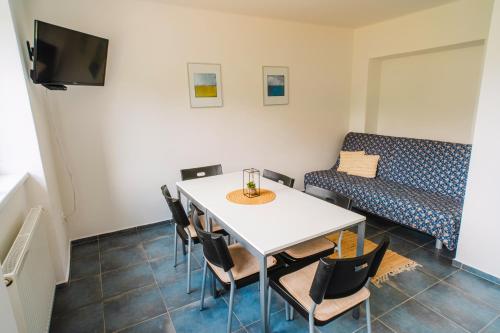 a room with a table and chairs and a couch at Apartmány Špička - Stříbrnice u sjezdovky in Staré Město