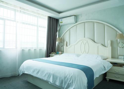 Un dormitorio con una gran cama blanca y una ventana en Morninginn, Yanling Jinggang Road en Ling