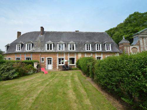 a large brick house with a large yard at Holiday home in a historic building near Montreuil in Gouy-Saint-André