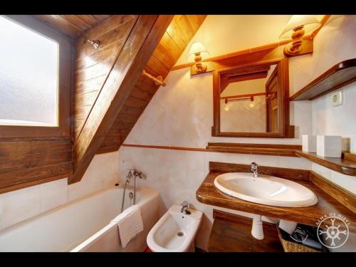 a bathroom with a sink and a bath tub at MULLERES de Alma de Nieve in Arties