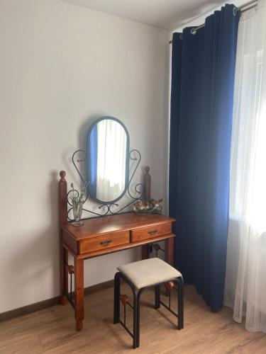 a dressing table with a mirror and a stool at Дом для отдыха на Фонтане in Odesa