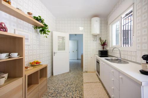 a kitchen with a sink and a white refrigerator at CASA DE MECA, a 100m de la playa in Los Caños de Meca