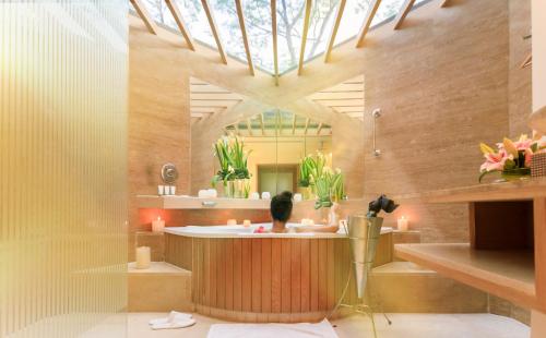 a bathroom with a bath tub and a sink at The Westin Sohna Resort & Spa in Gurgaon