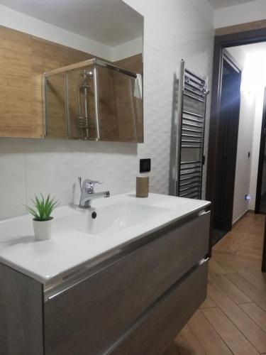 a kitchen with a white sink and a room at Casa vacanze Amalfitan Coast in Vietri sul Mare