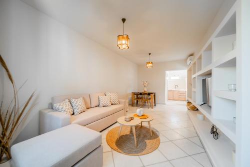 a living room with a couch and a table at Petradia Villas in Naxos Chora