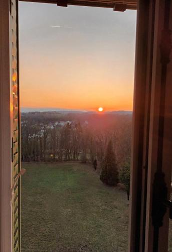 a view from a window of a sunset at Le Manoir du Cerf in Gaillon-sur-Montcient