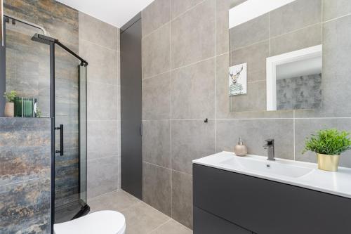 a bathroom with a sink and a shower at Basztowa Apartments in Kraków