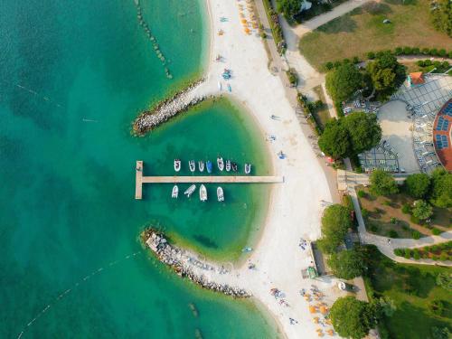 an aerial view of a beach with a pier at Glamping Istrië in Fažana
