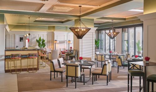 a restaurant with tables and chairs and a bar at Grand Hyatt La Manga Club Golf & Spa in La Manga del Mar Menor