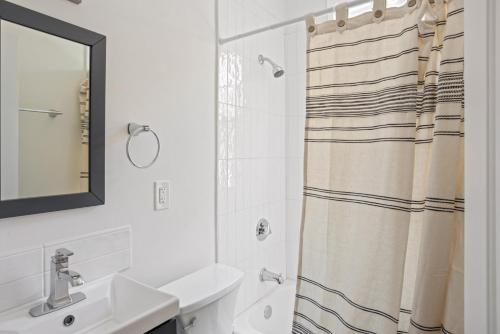 a bathroom with a shower curtain and a sink at Bright Brighton 1BR near T Shops BOS-775 in Boston