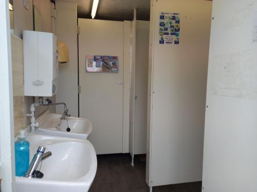 a bathroom with a sink and a toilet in it at Pen y Buarth Pod - Caravan Site in Caernarfon