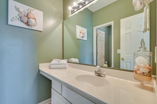 a bathroom with a sink and a mirror at 4 Mi to Broadway at the Beach Golf Resort Getaway in Myrtle Beach