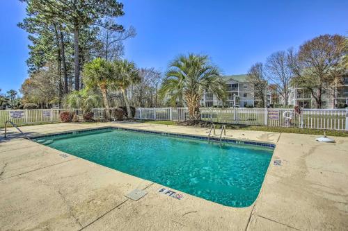 a swimming pool in a yard with a fence and trees at 4 Mi to Broadway at the Beach Golf Resort Getaway in Myrtle Beach