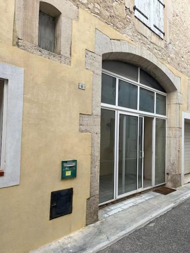 a building with a window on the side of it at La cave à Papé in Peyriac-de-Mer